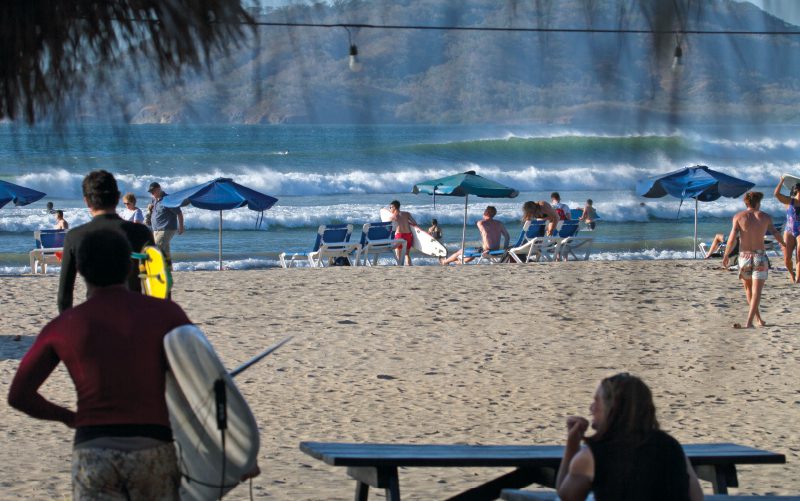 watching surfers on the beach tamarindo costa rica