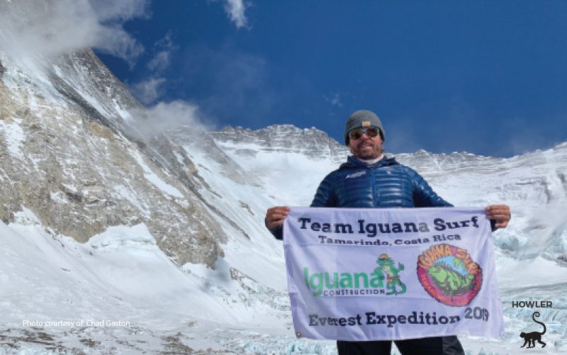 surf local Chad Gaston from tamarindo costa rica, holds up his shop's flag on mount everest