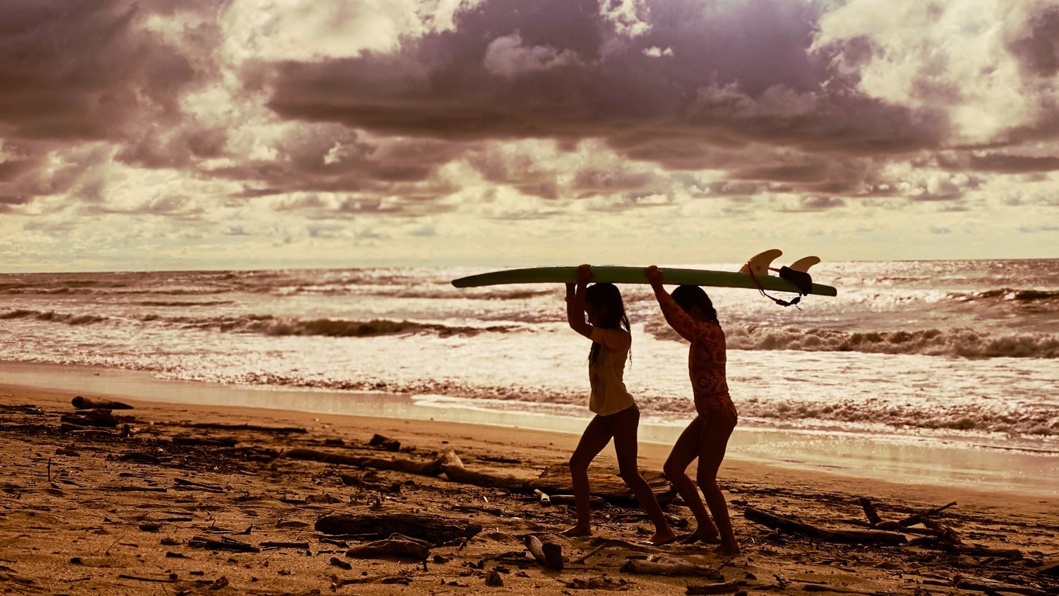 ari and kiala with surfboard